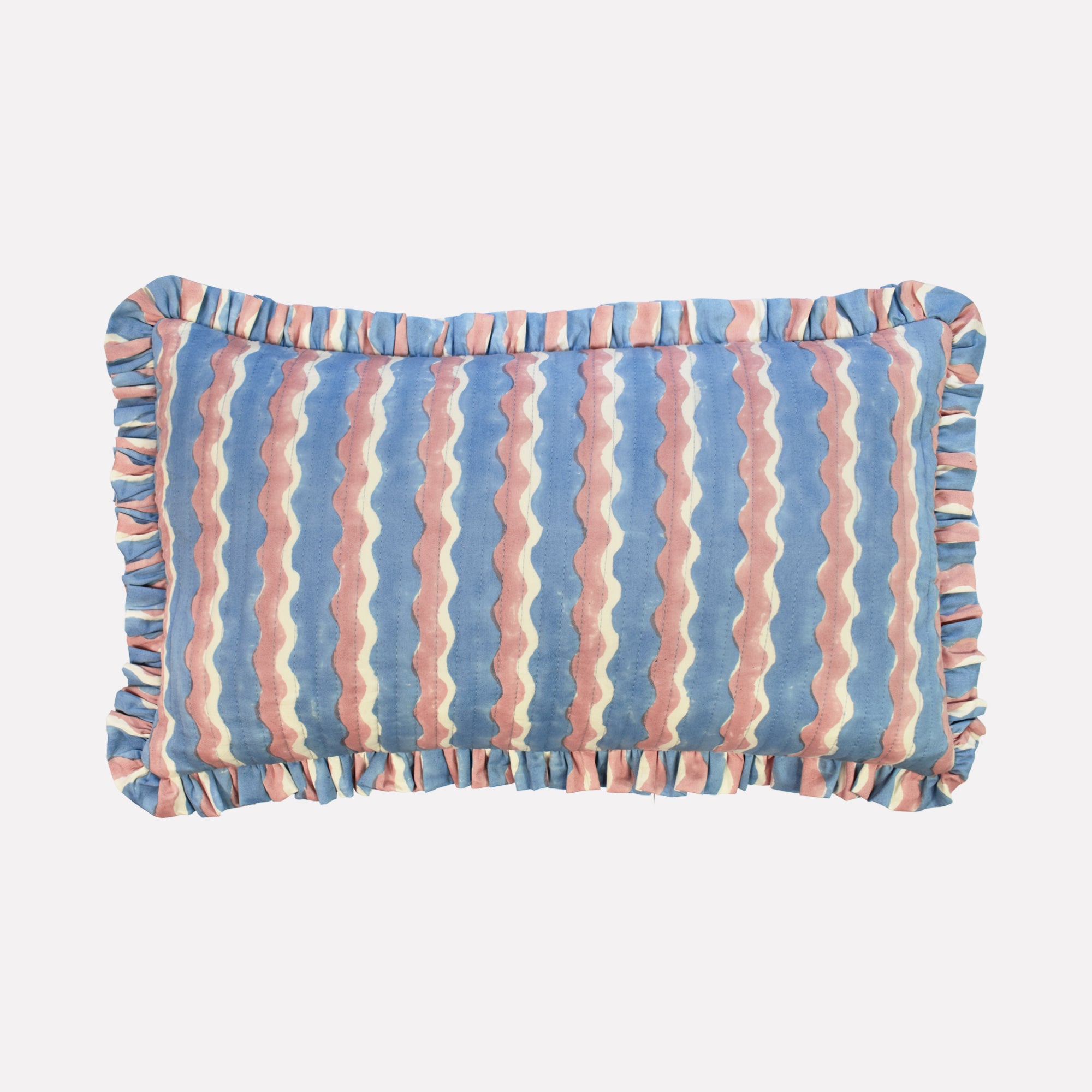 Small cotton quilted cushion printed with blue and pink striped wave pattern and frill border