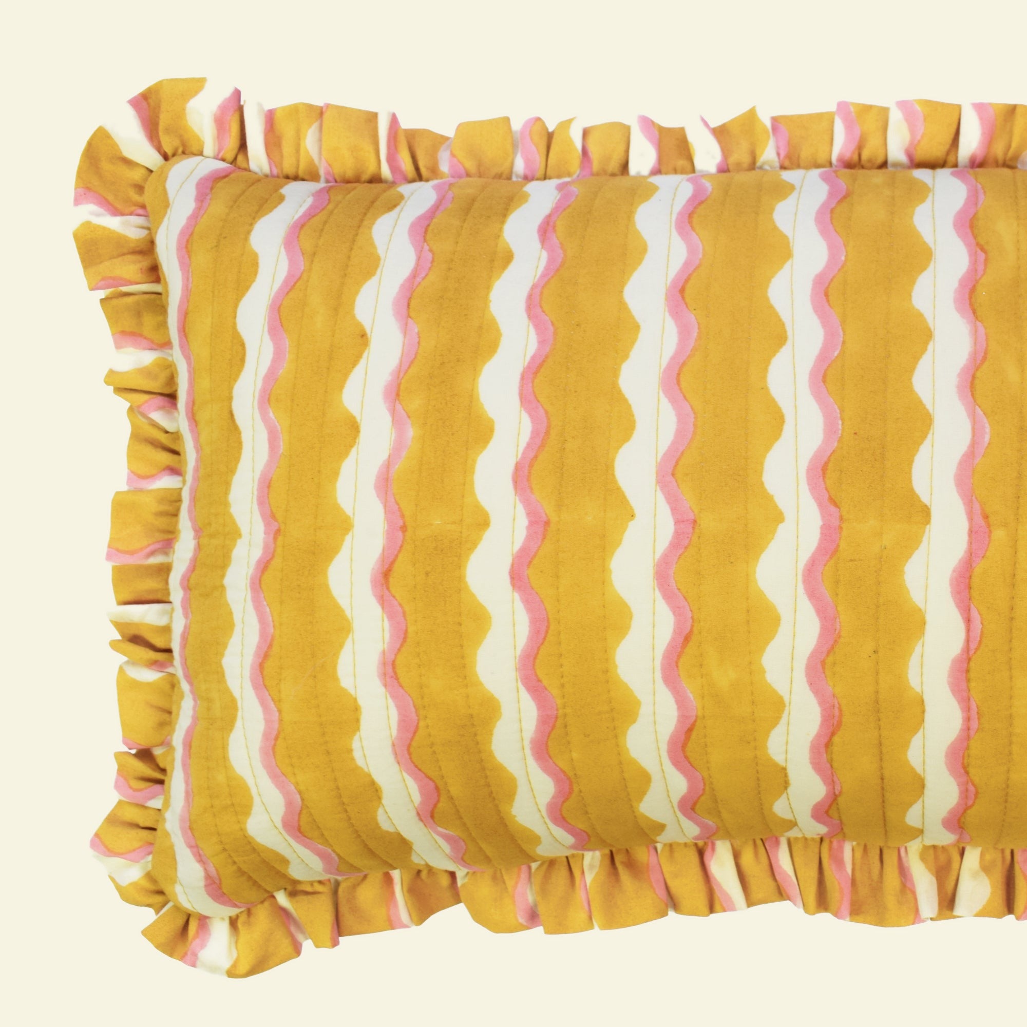 Close-up detail of Yonder Living Wiggle honey organic cotton quilted frill cushion, hand block-printed in Jaipur