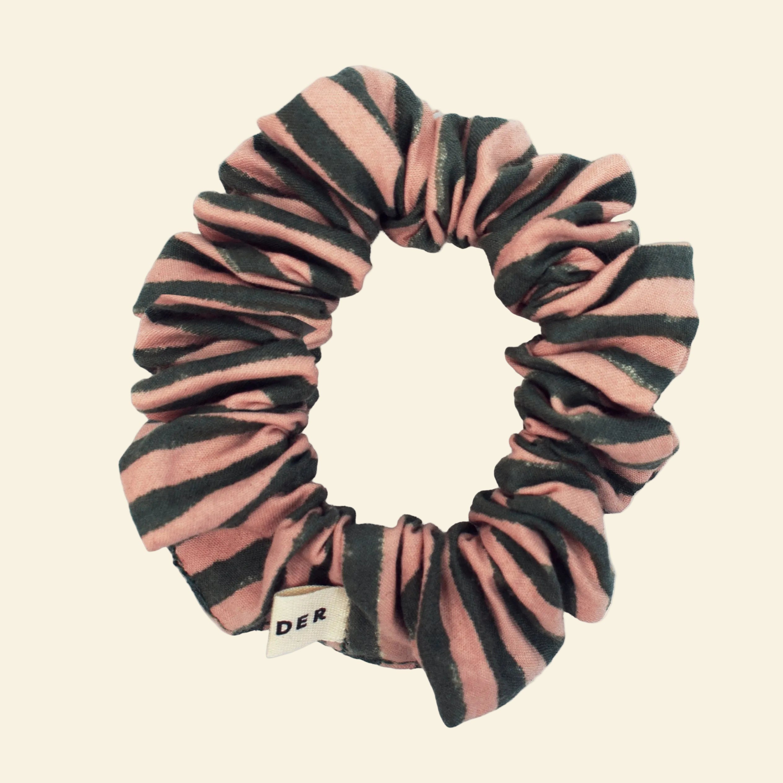 Close-up of a single Yonder organic cotton mini scrunchie in green stripe, hand block-printed in Jaipur