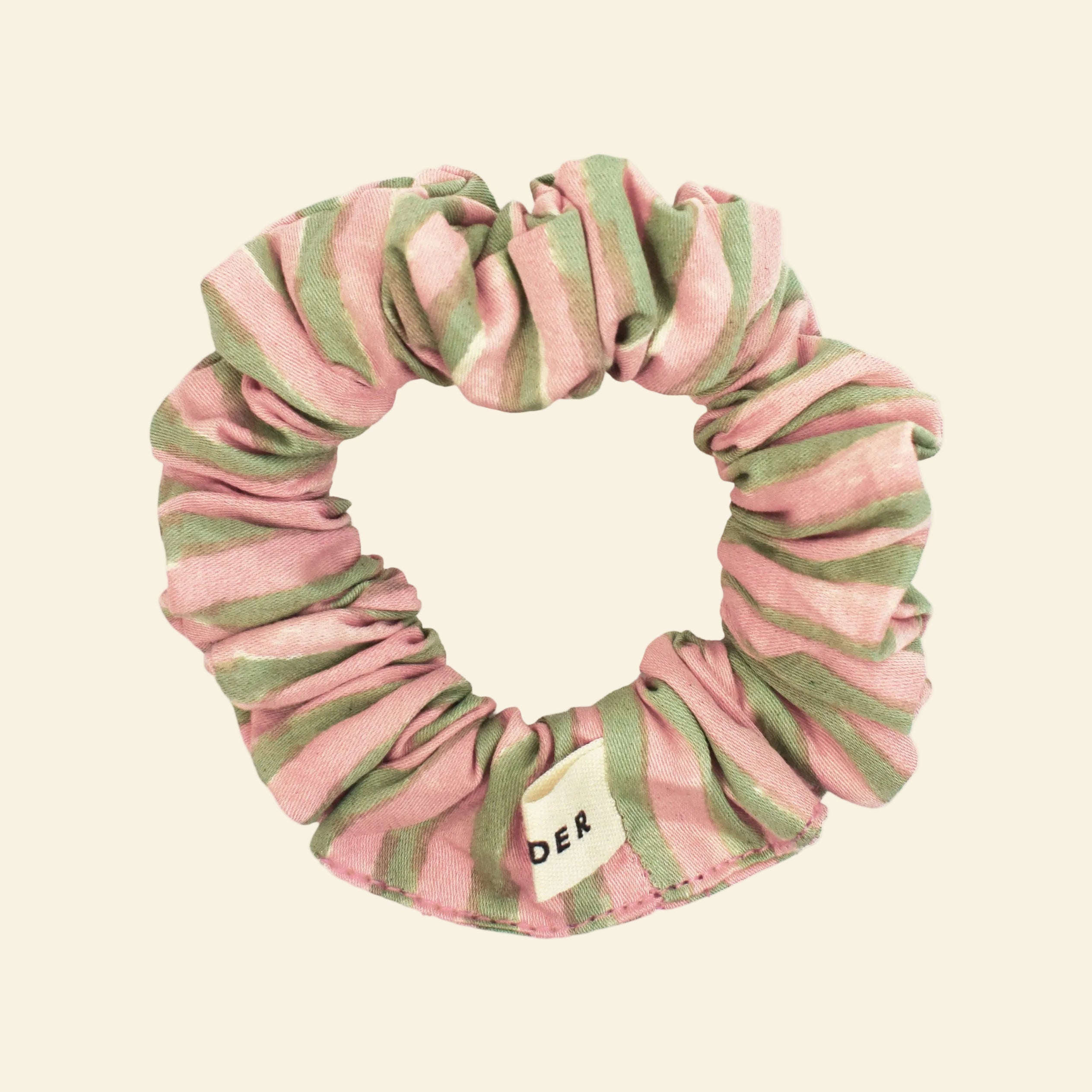 Close-up of a single Yonder organic cotton mini scrunchie in green stripe, hand block-printed in Jaipur