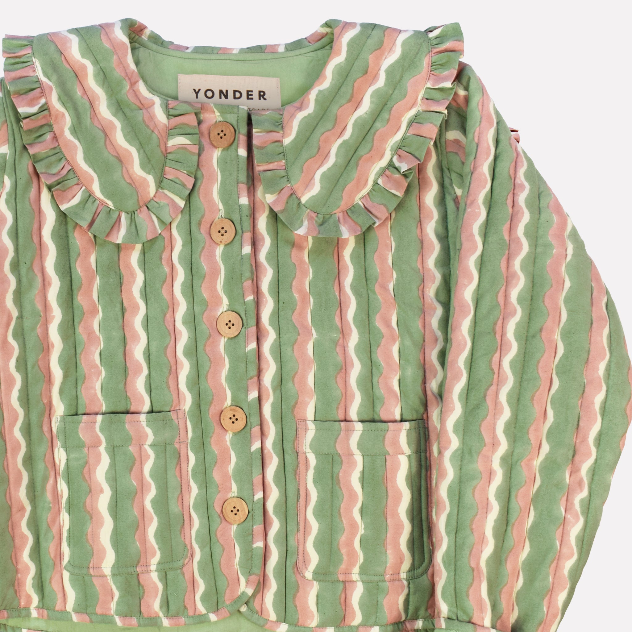 Closeup of cotton quilted jacket printed with mint green and pink striped wave pattern and frill collar