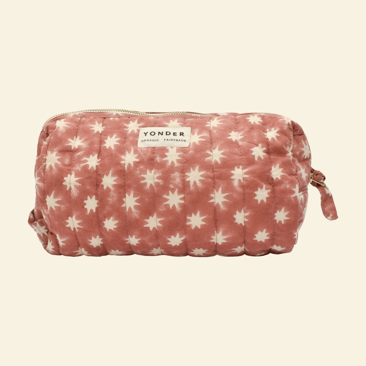 Close-up of Yonder ginger Cosmic Loaf wash bag, quilted organic cotton with brass zip, hand block-printed in Jaipur