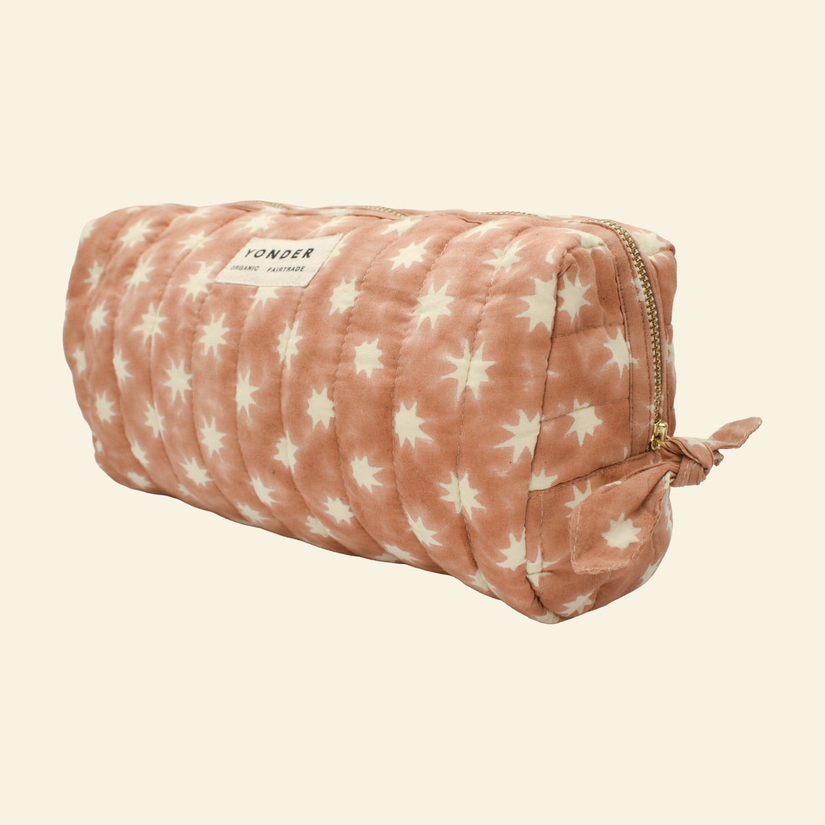 Close-up of Yonder peanut brown Cosmic Loaf wash bag, quilted organic cotton with brass zip, hand block-printed in Jaipur