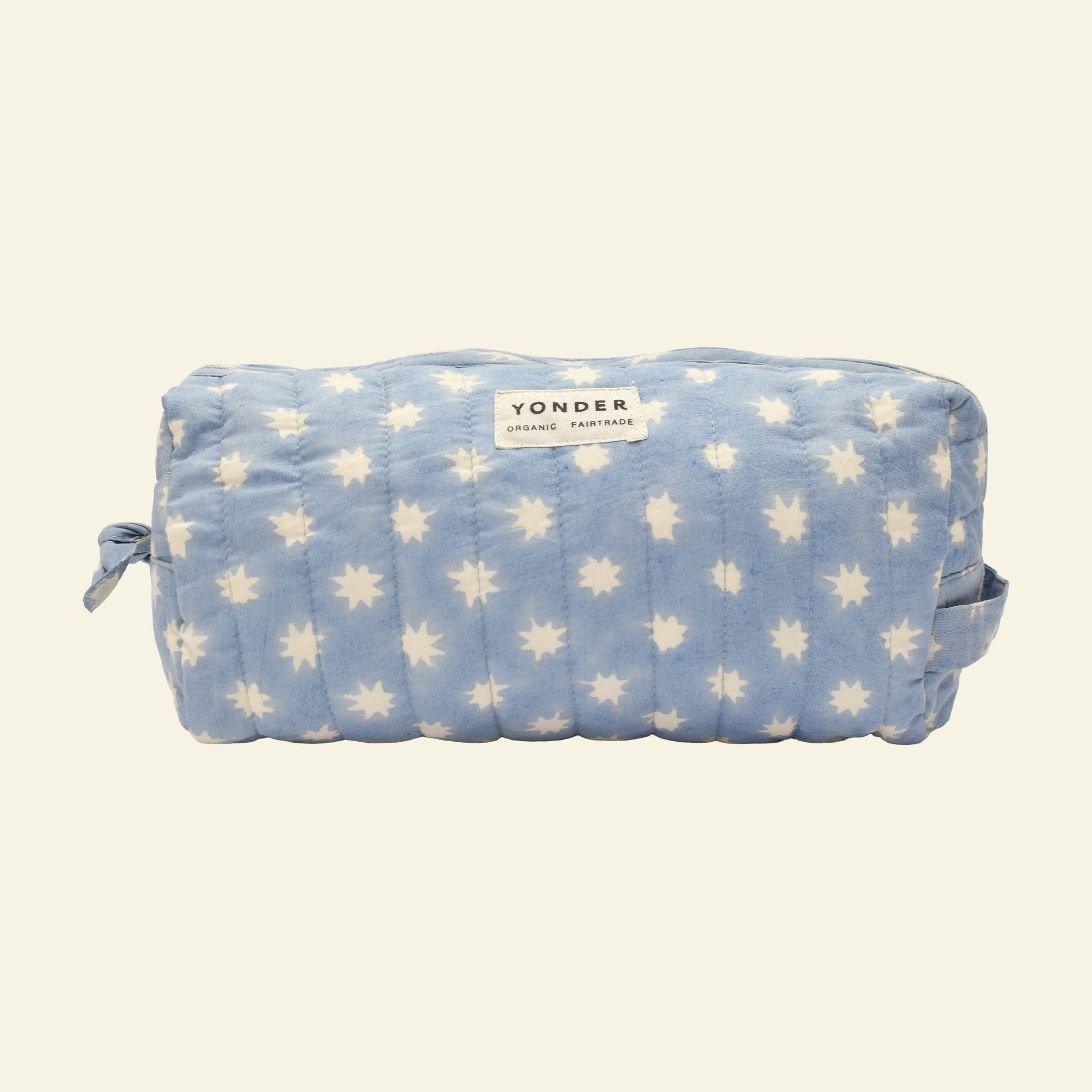 Close-up of Yonder sky blue Cosmic Loaf wash bag, quilted organic cotton with brass zip, hand block-printed in Jaipur