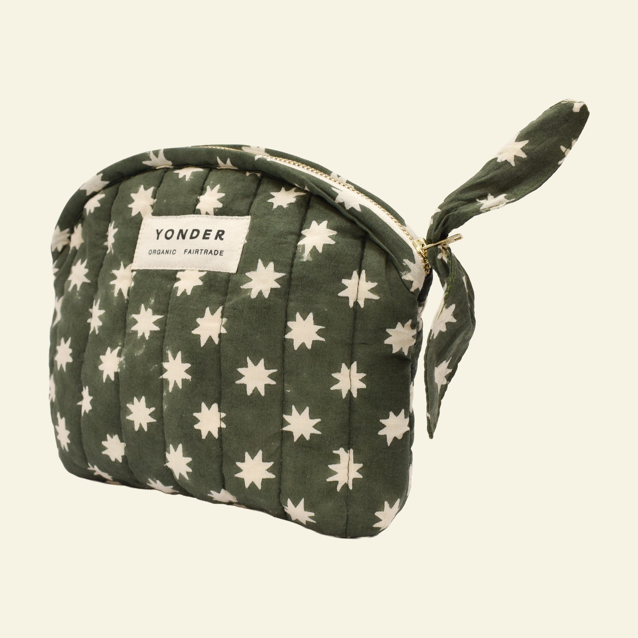 Close-up of Yonder fern green Cosmic quilted zip pouch, organic cotton with brass zip, hand block-printed in Jaipur