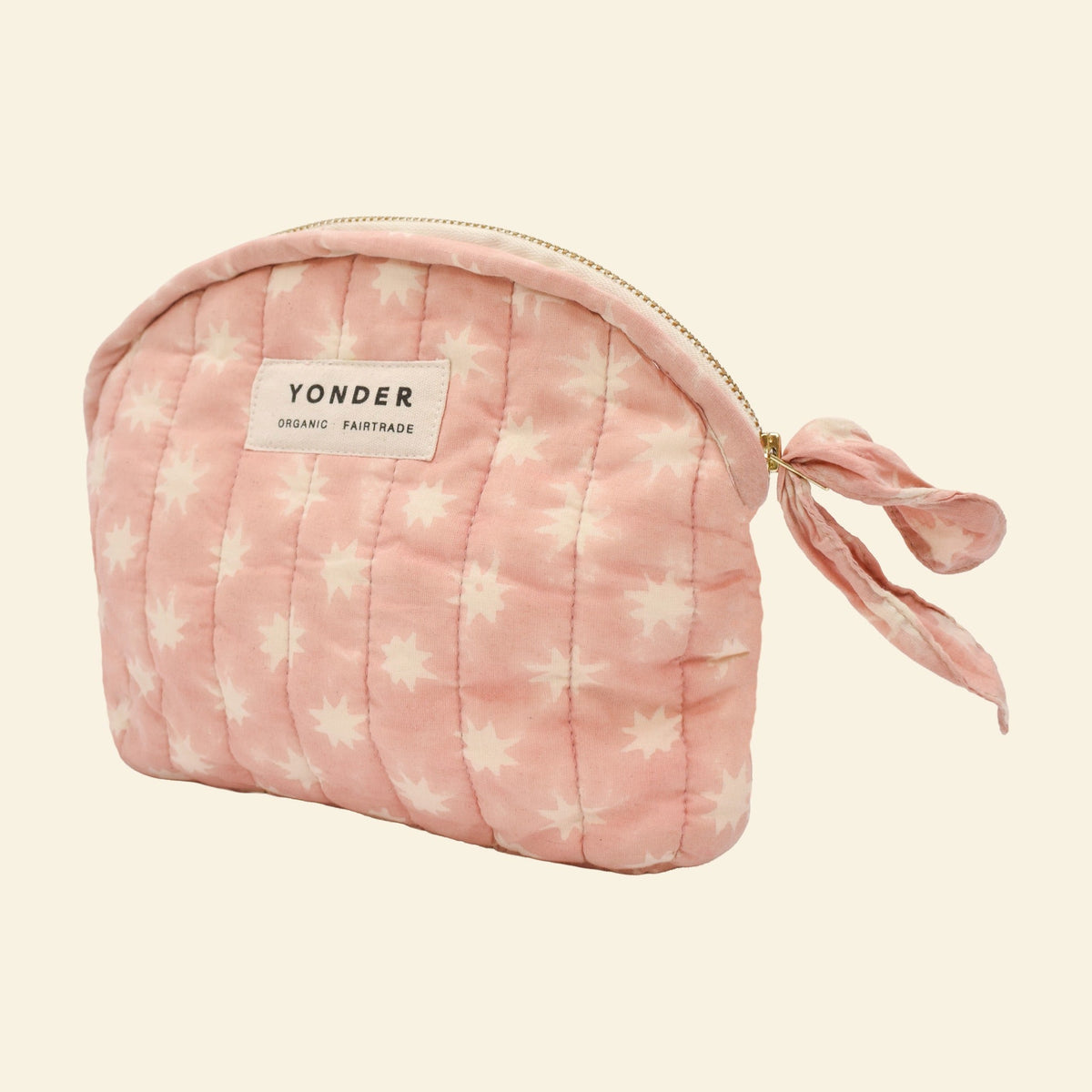 Close-up of Yonder blush pink Cosmic quilted zip pouch, organic cotton with brass zip, hand block-printed in Jaipur