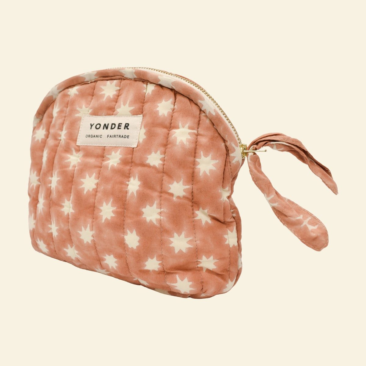 Close-up of Yonder peanut brown Cosmic quilted zip pouch, organic cotton with brass zip, hand block-printed in Jaipur