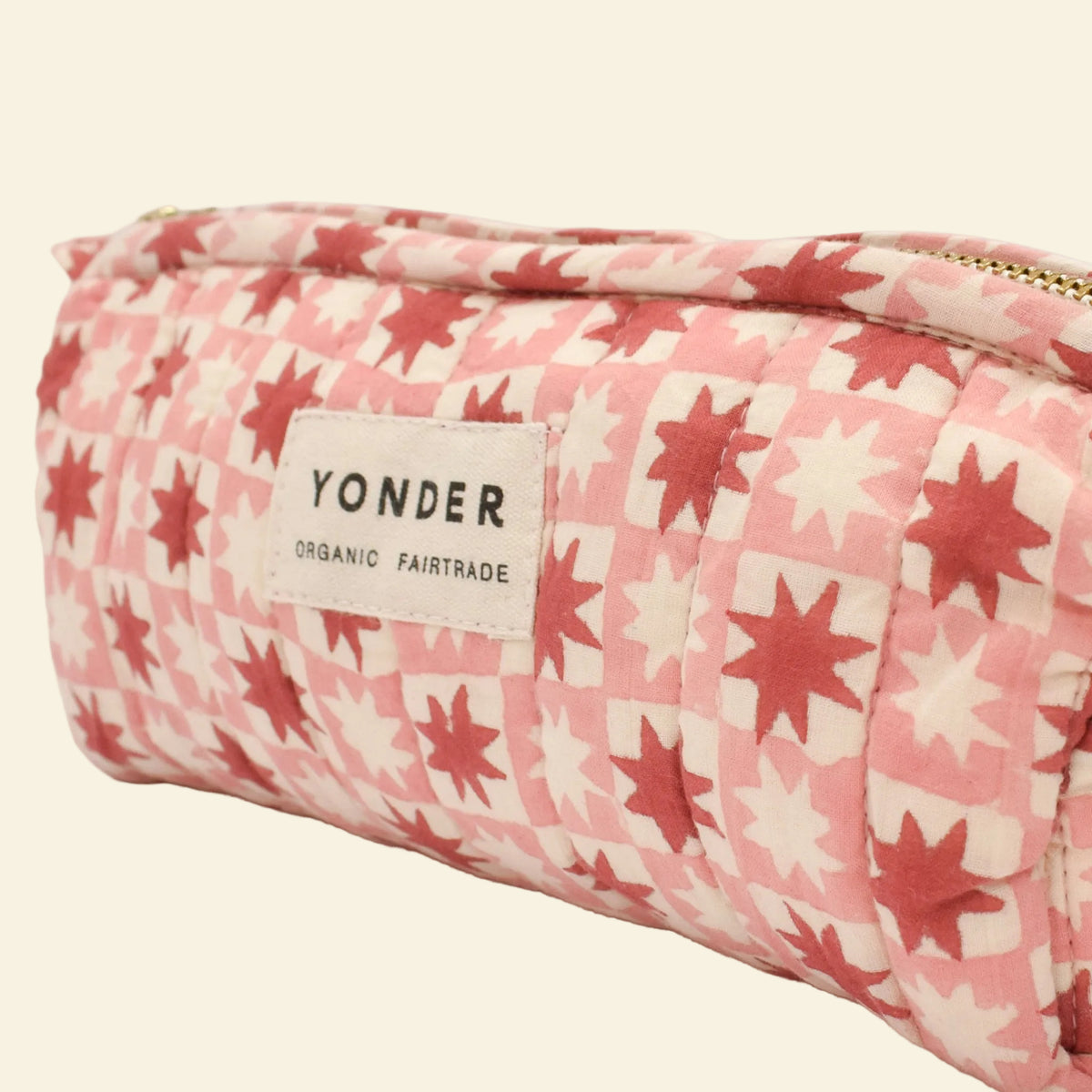 Yonder soft organic cotton brioche wash bag in jam-red pinwheel star print, close-up, hand block-printed in Jaipur
