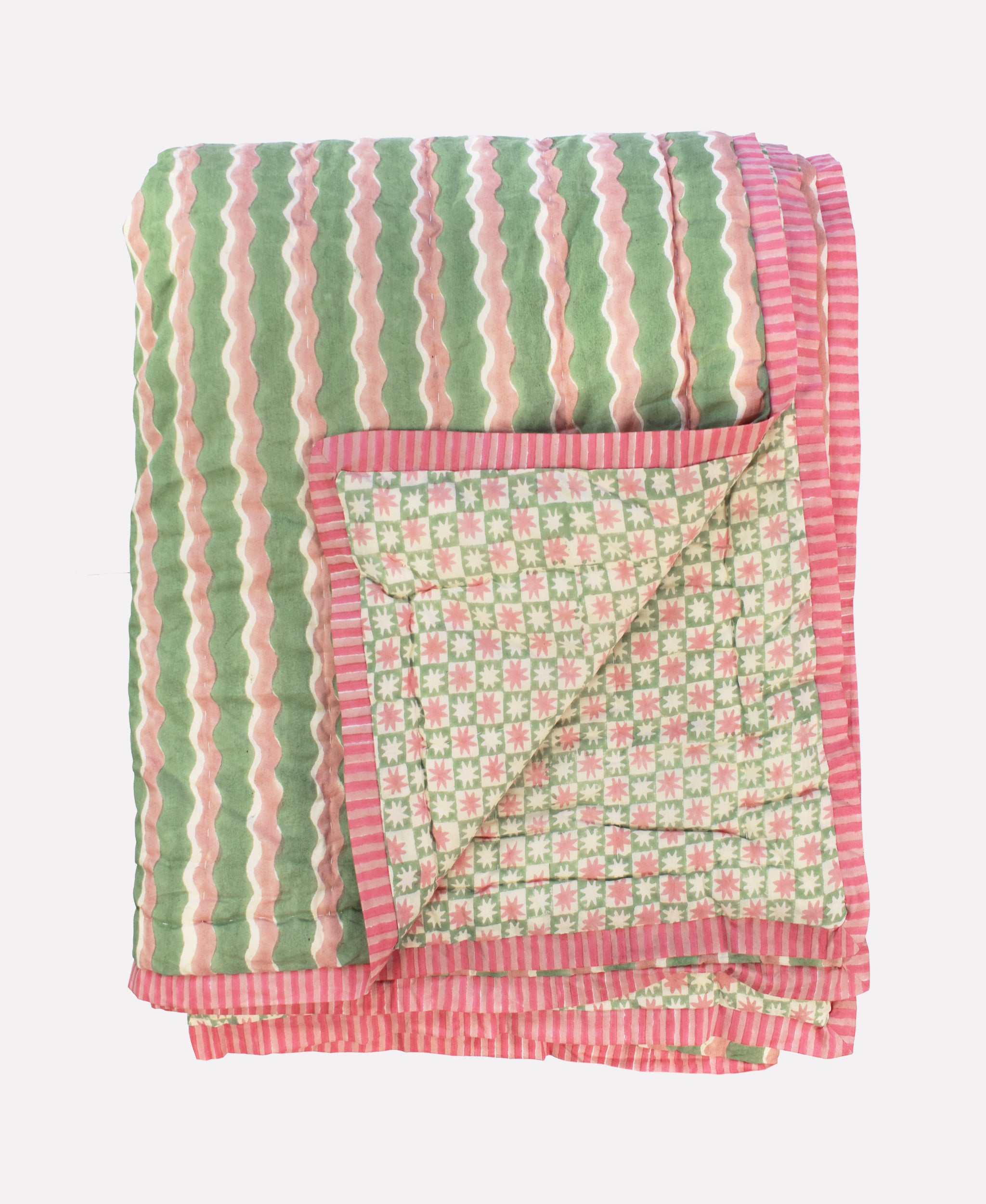 Cotton quilt printed with green and pink striped wave and star patterns and pink striped border