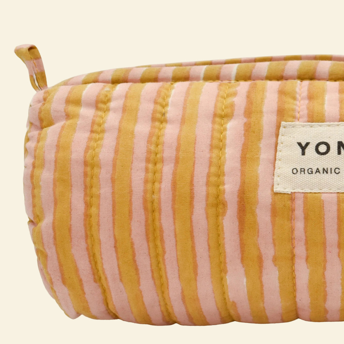 Yonder soft organic cotton brioche wash bag in biscuit and soft blush candy stripe with brass zip, hand block-printed in Jaipur