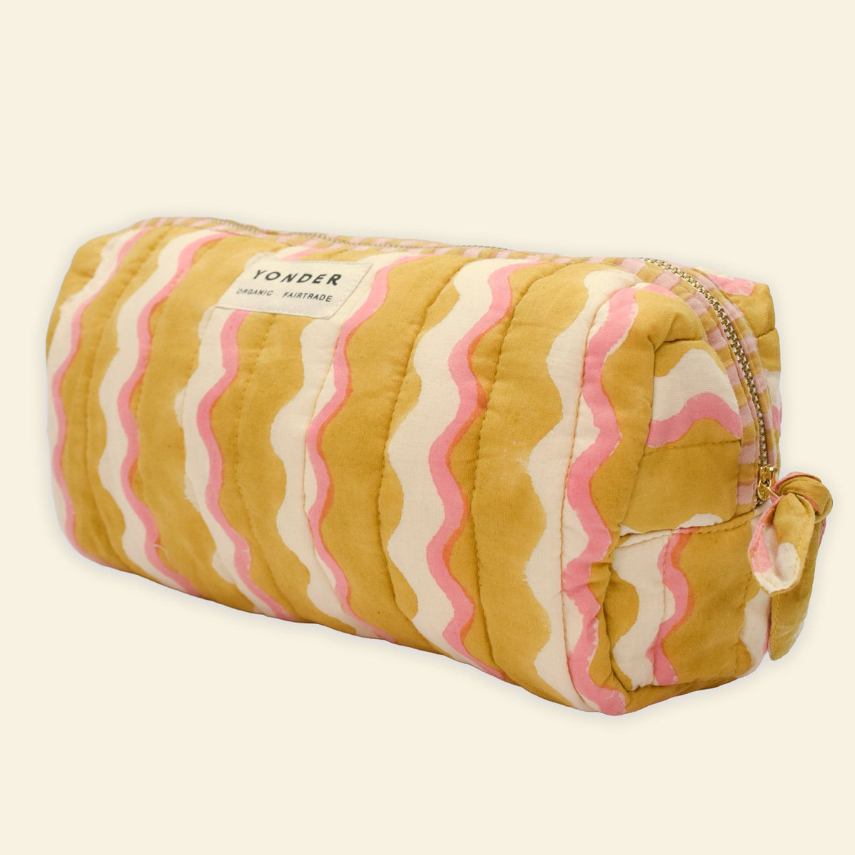 Yonder organic cotton quilted wash bag in golden honey wavy stripe print, front view, hand block-printed in Jaipur