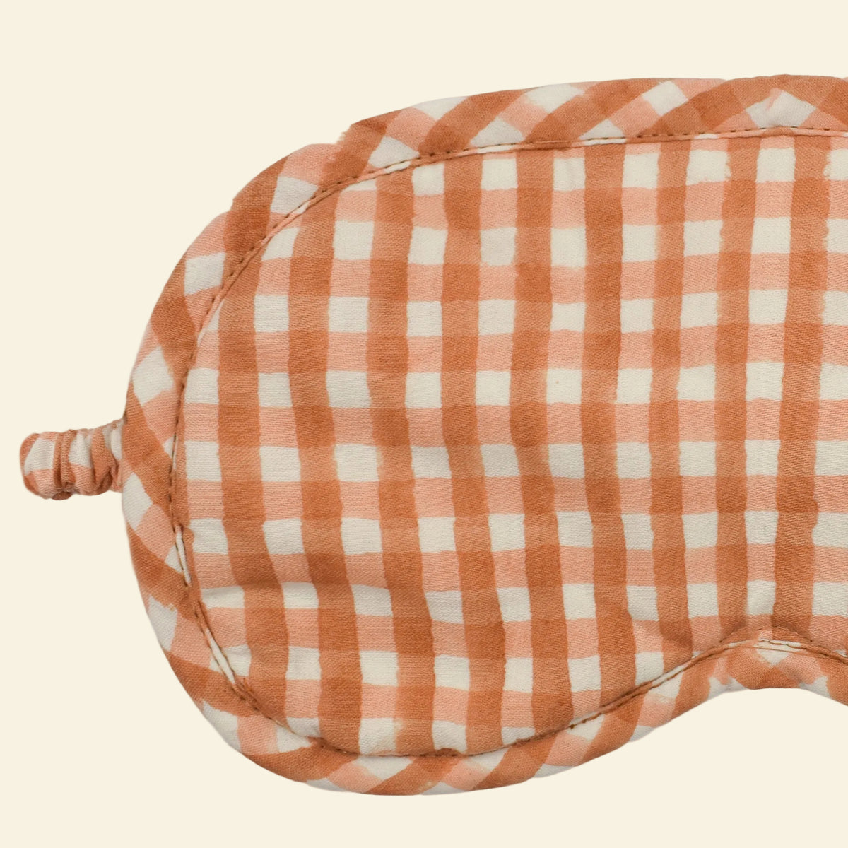 Close-up of Yonder Fudge eye mask showing the caramel and ivory hand block-printed gingham