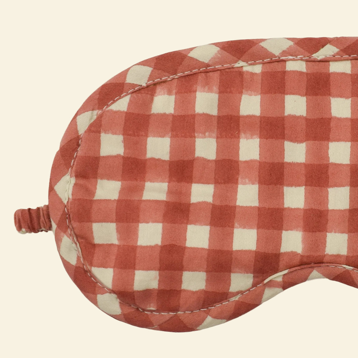 Close-up of Yonder Ginger eye mask showing the red and white hand block-printed gingham