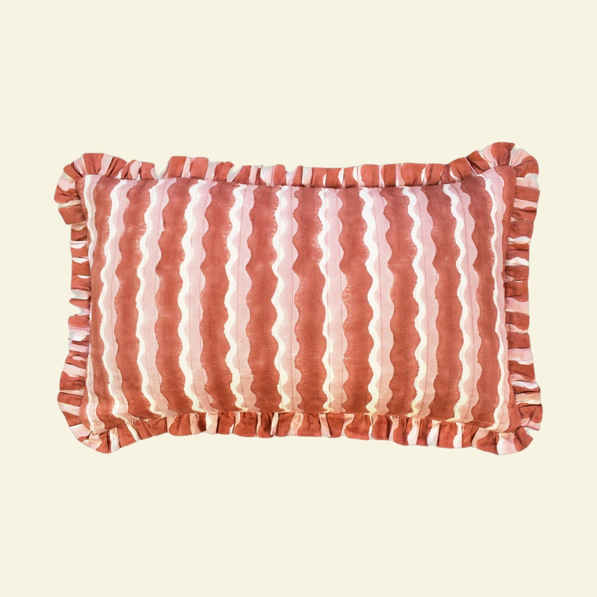 Yonder Living hand block-printed organic cotton quilted frill cushion in Whirly ginger, warm ginger waves on cream, small