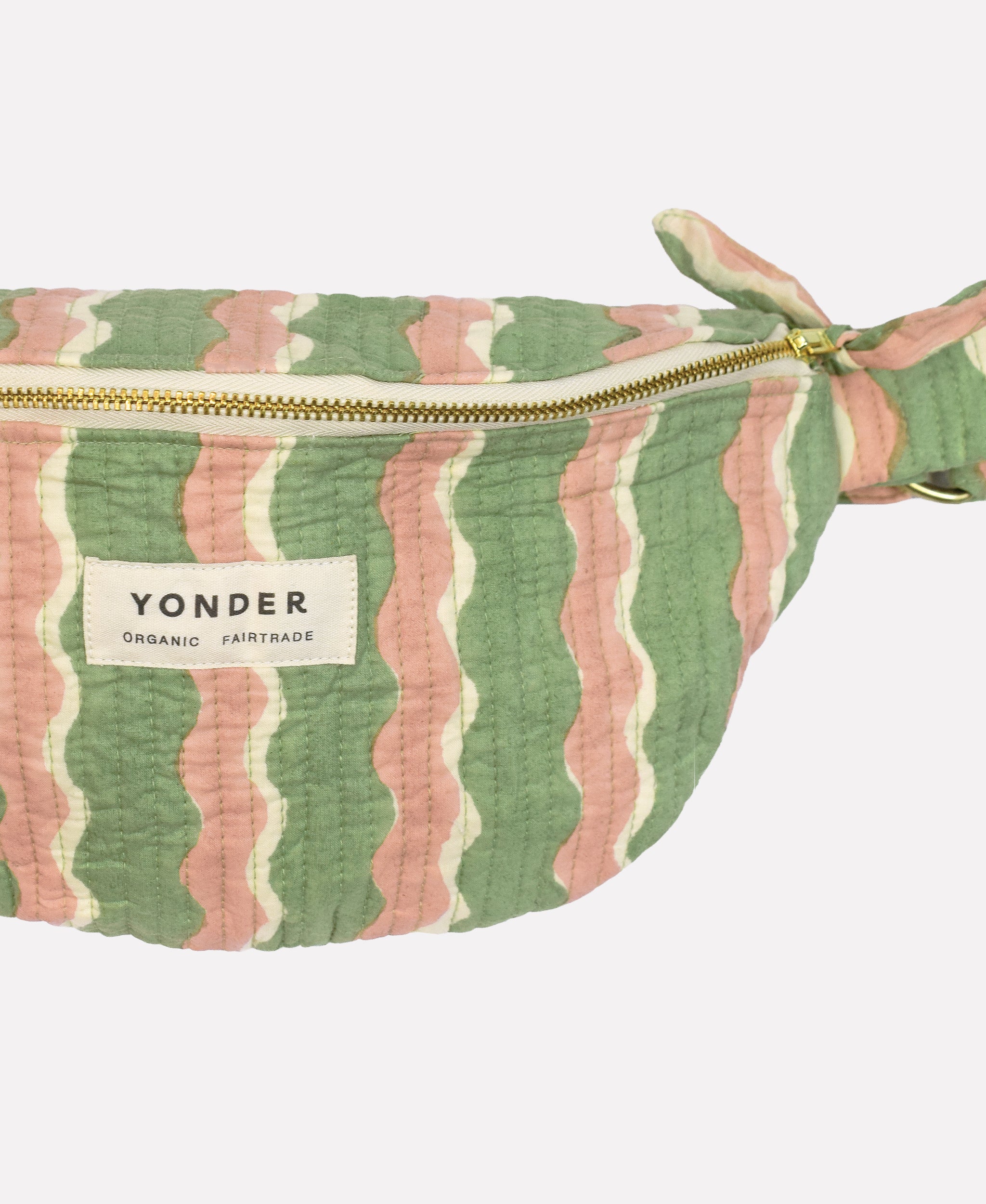 Closeup of cotton quilted bumbag/fanny pack printed with green and pink striped wave pattern