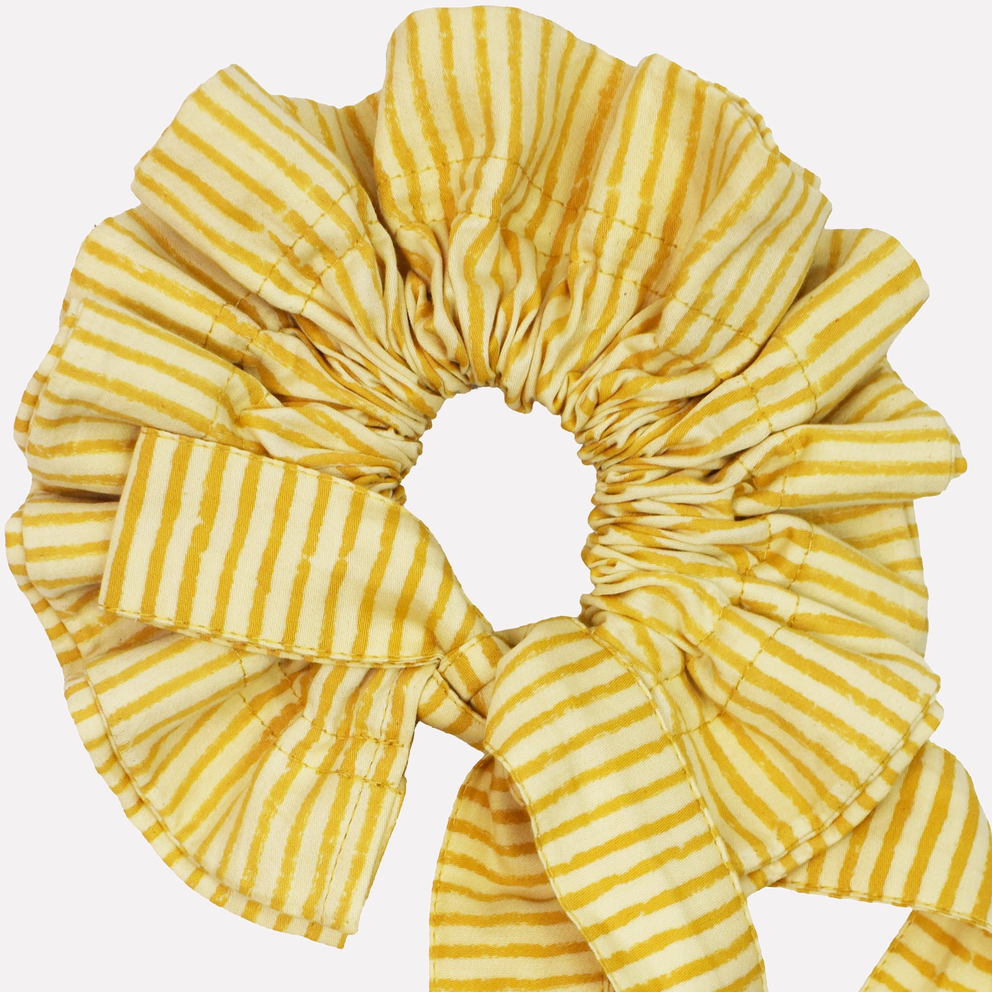 Closeup of cotton tie collar/scrunchie with ribbons printed with yellow striped pattern