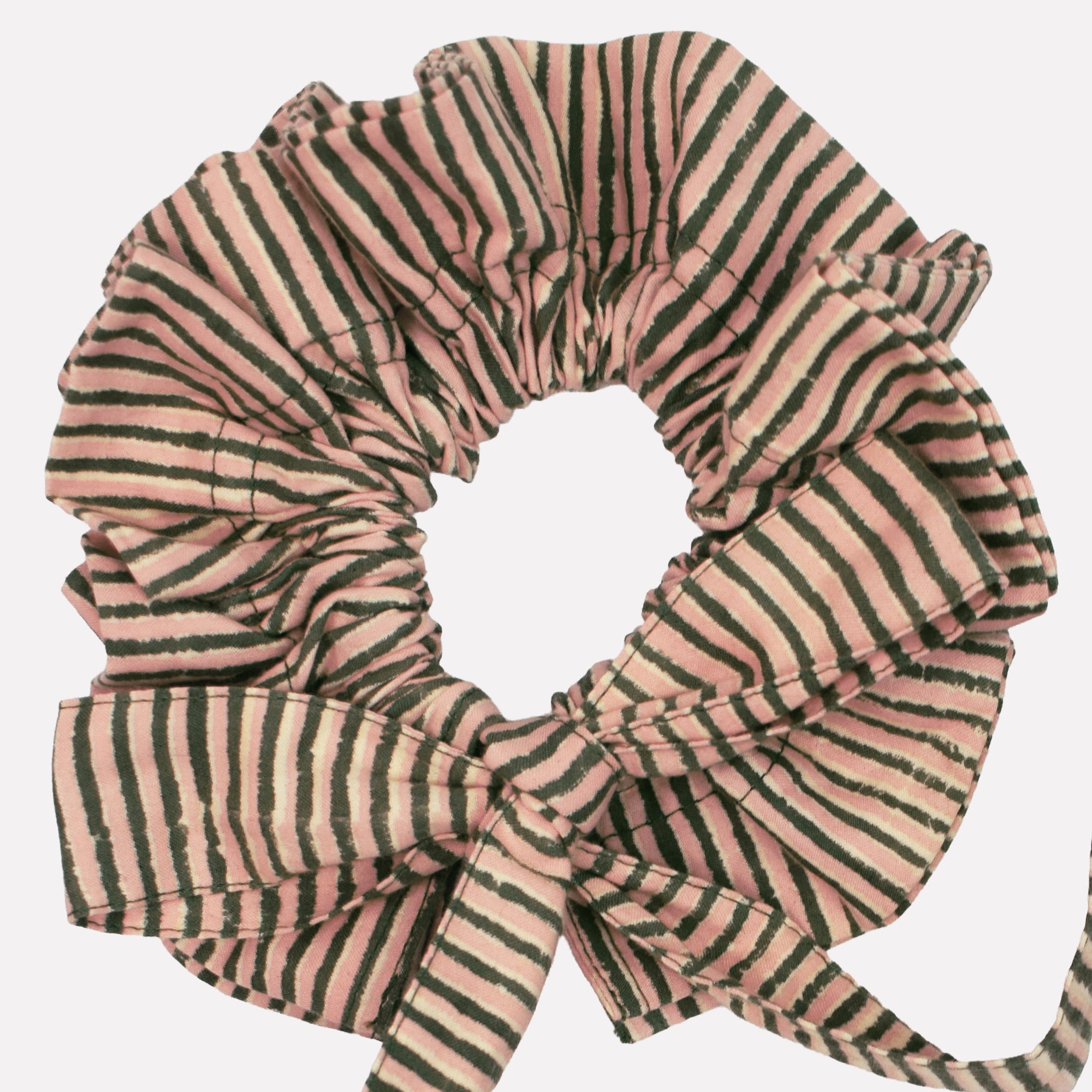 Closeup of cotton tie collar/scrunchie with ribbons printed with green and pink striped pattern