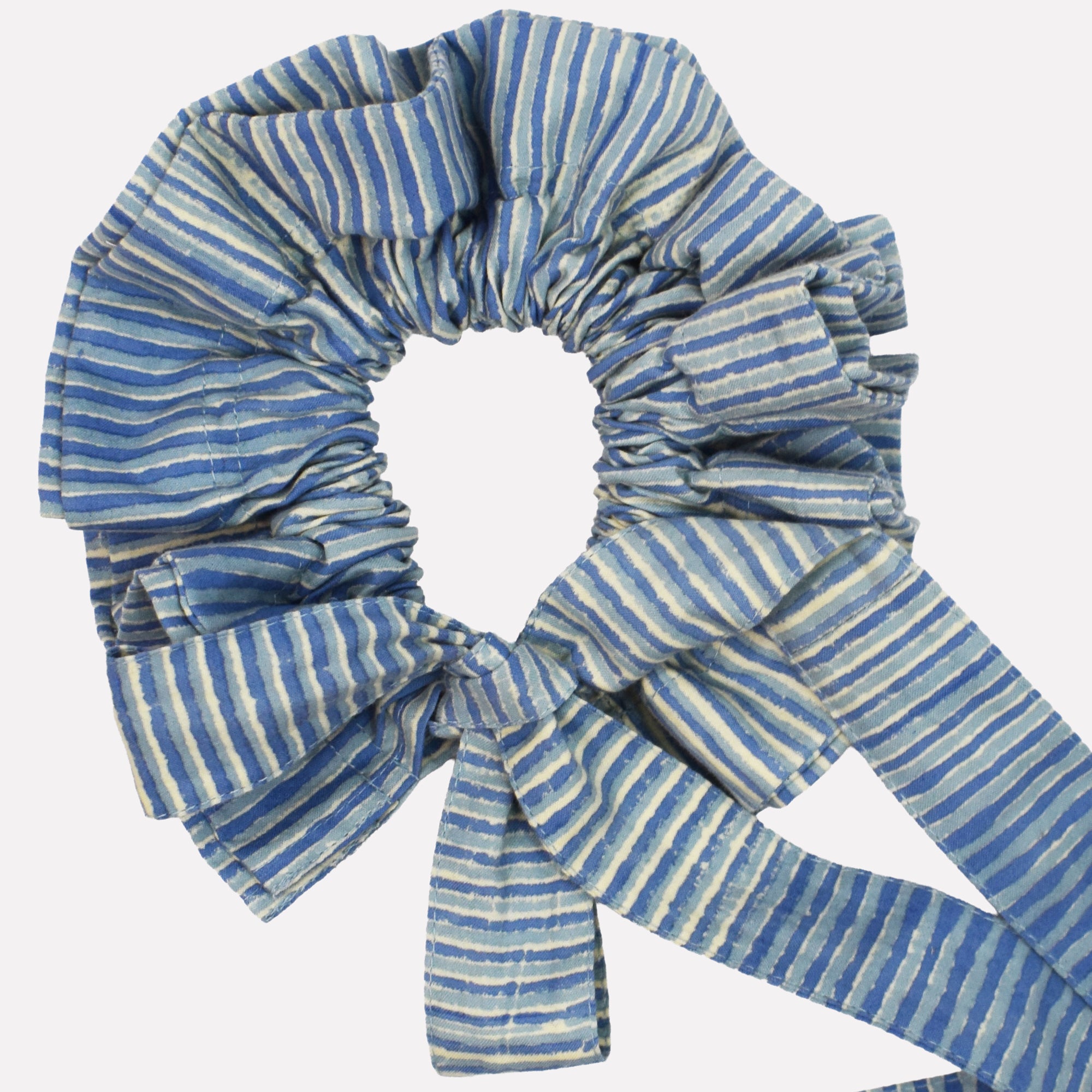 Closeup of cotton tie collar/scrunchie with ribbons printed with blue striped pattern