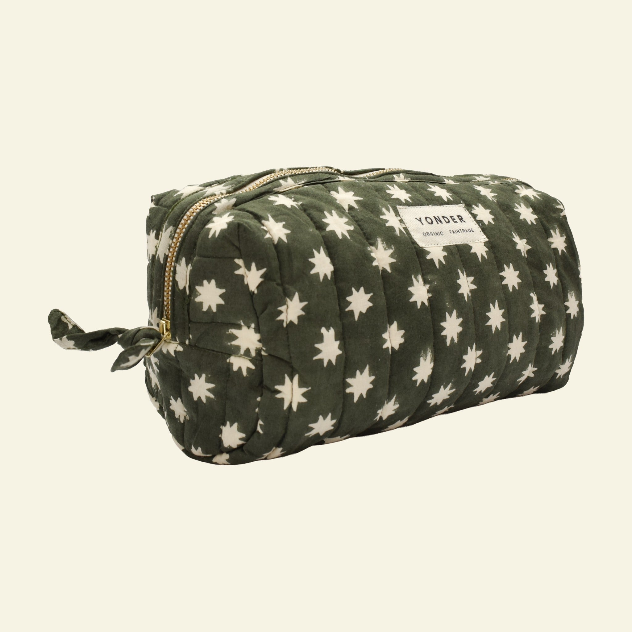 Close-up of Yonder fern green Cosmic Loaf wash bag, quilted organic cotton with brass zip, hand block-printed in Jaipur