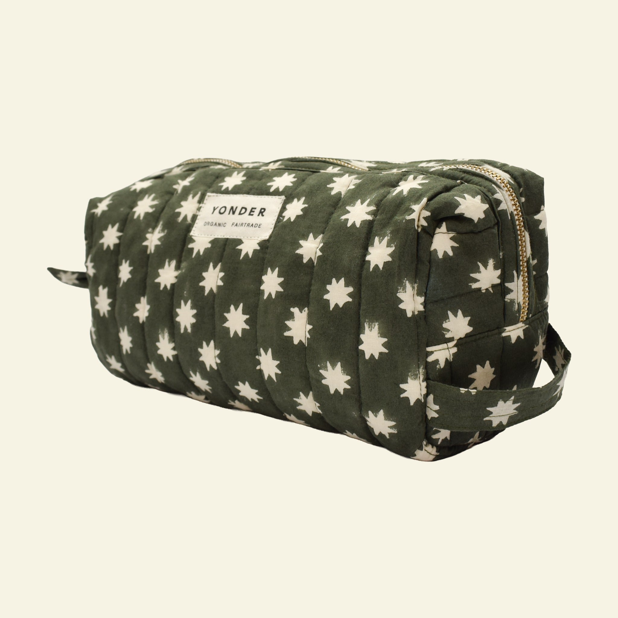 Close-up of Yonder fern green Cosmic Loaf wash bag, quilted organic cotton with brass zip, hand block-printed in Jaipur