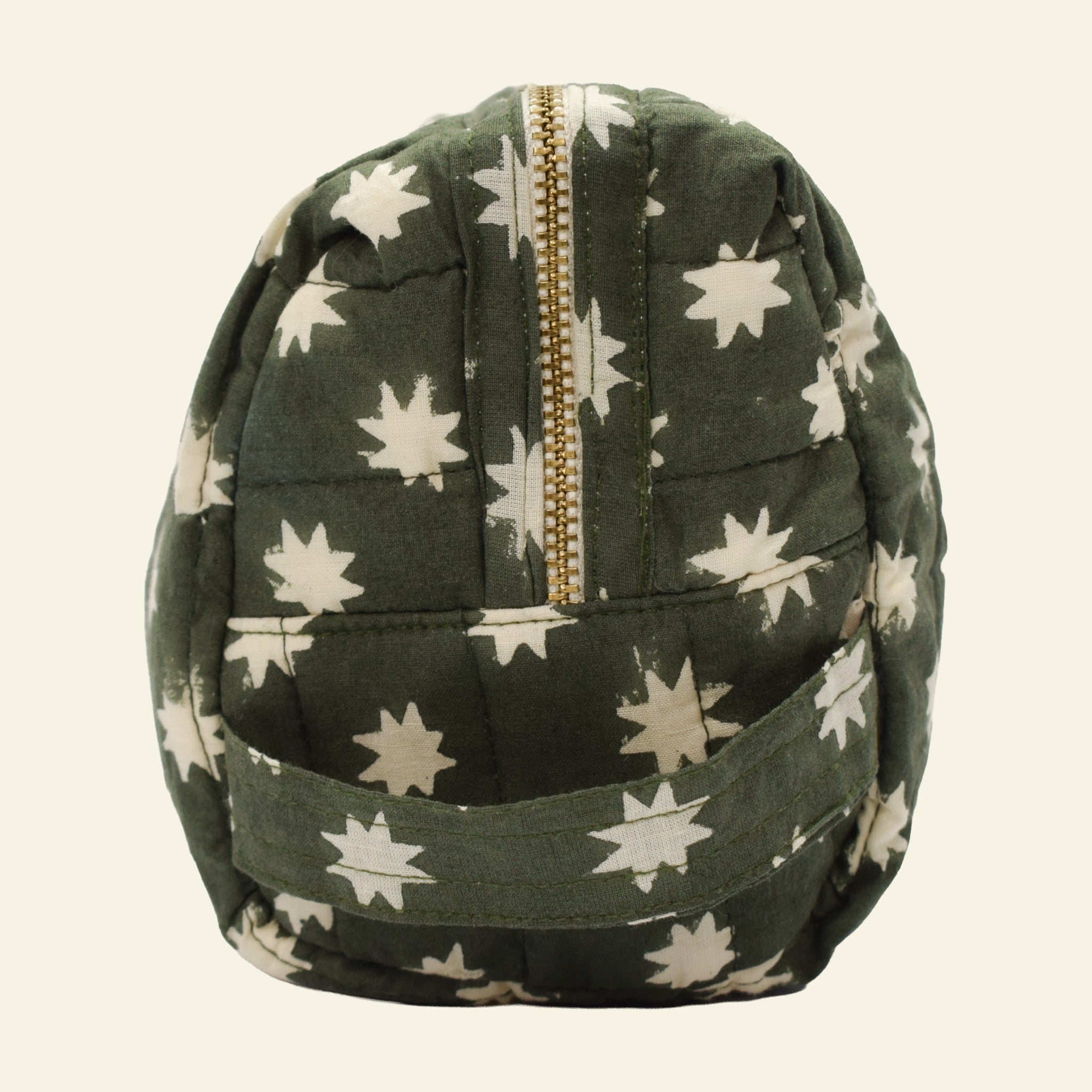 Close-up of Yonder fern green Cosmic Loaf wash bag, quilted organic cotton with brass zip, hand block-printed in Jaipur