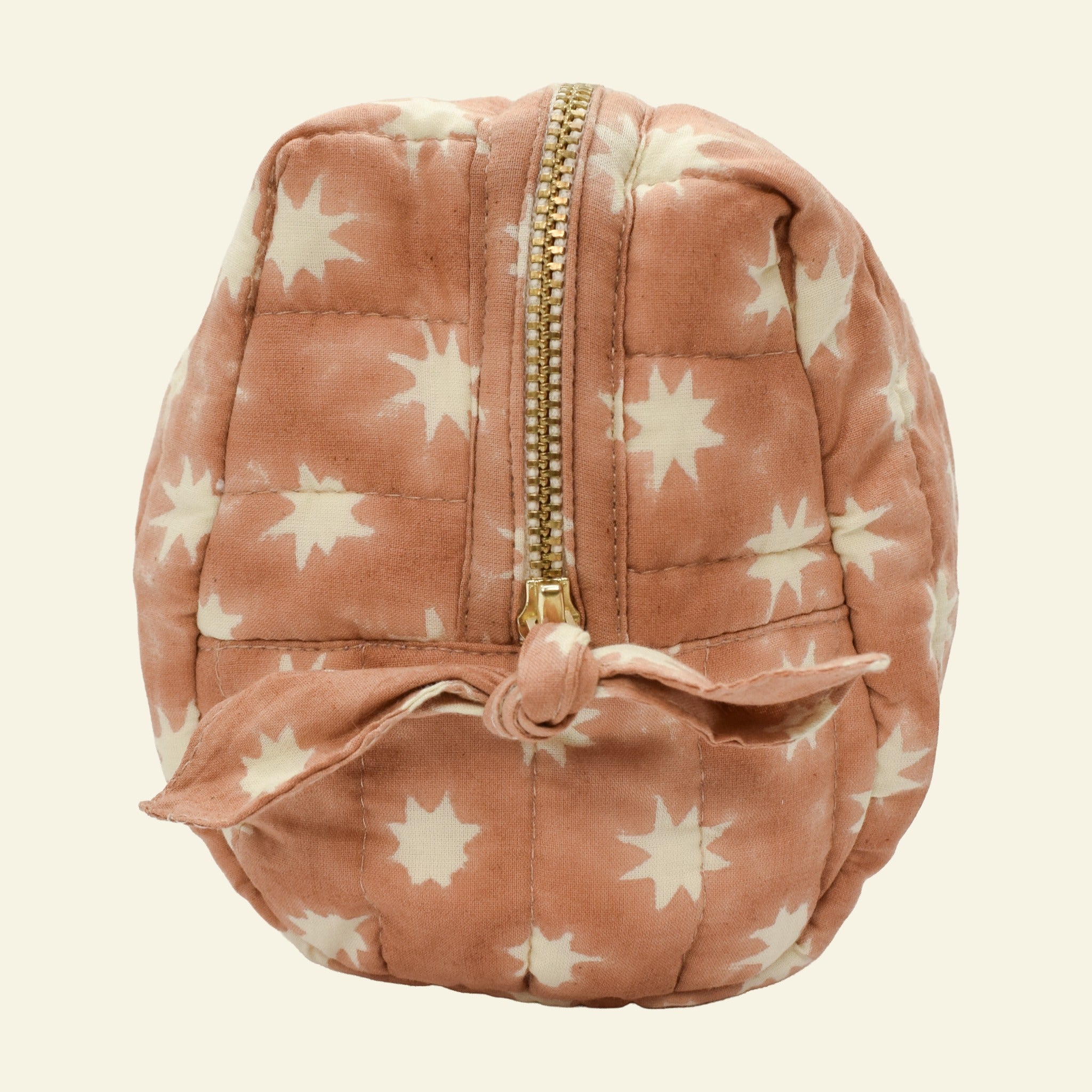 Close-up of Yonder peanut brown Cosmic Loaf wash bag, quilted organic cotton with brass zip, hand block-printed in Jaipur