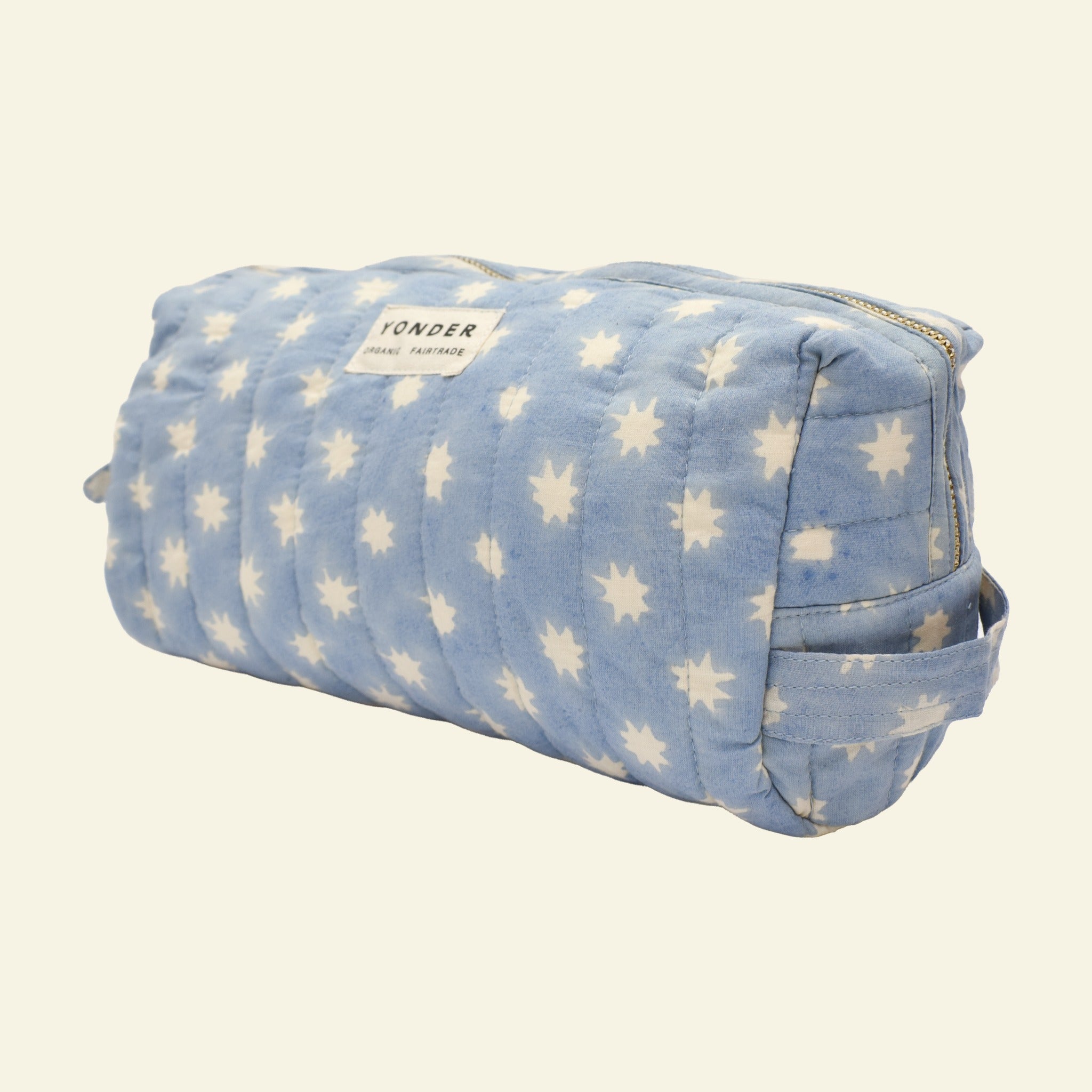 Close-up of Yonder sky blue Cosmic Loaf wash bag, quilted organic cotton with brass zip, hand block-printed in Jaipur