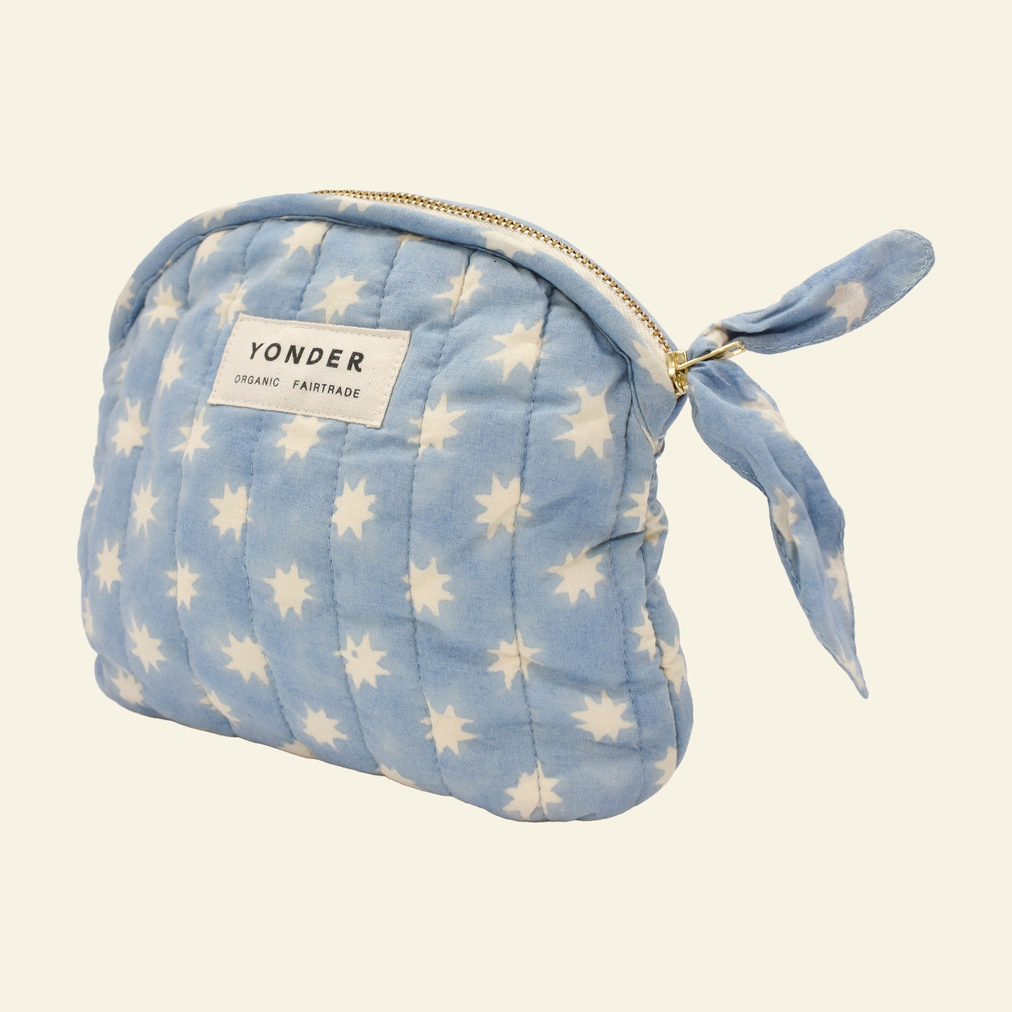 Close-up of Yonder sky blue Cosmic quilted zip pouch, organic cotton with brass zip, hand block-printed in Jaipur