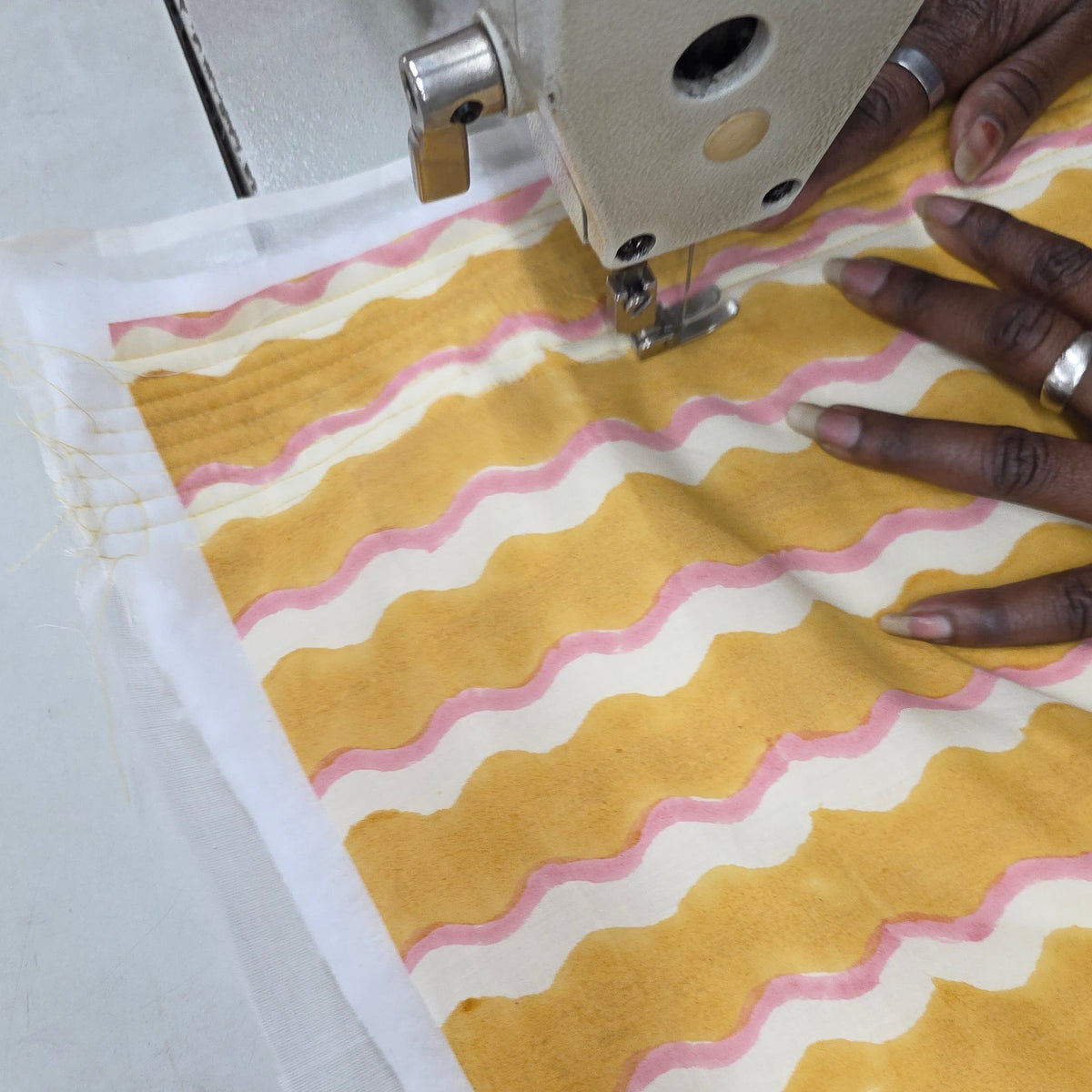 Yonder Wiggle Honey block-printed organic cotton being quilted by hand in Jaipur